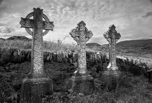 Celtic cross tombstones at a church graveyard on Abbey Island, County Kerry.