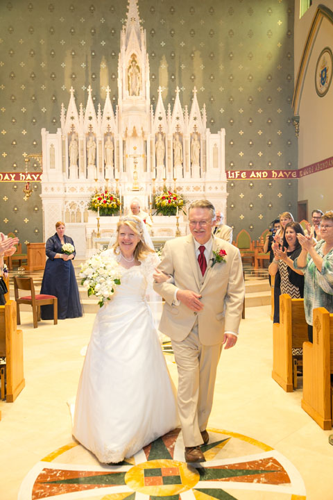 The bride and groom inside the newly-restored church. The altar was designed by James Renwick, who also designed St. Patrick's Cathedral in Manhattan.