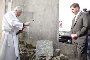 TOP: Martin J. Walsh, Mayor of Boston unveils the Foundation Stone for the Emigrants Commemorative Center in Carna in Connemara in September. Project chairperson, Máirtin Ó Catháin (left) with the mayor. Mayor Walsh’s late father, John Walsh was a native of Carna and his mother Mary is a native of the neighboring parish of Ros Muc. Both parishes are in the Gaeltacht – the Irish speaking area of Ireland. CENTER: Local parish priest, Fr. Padraig Standún blesses the Foundation Stone as Mayor Walsh of Boston looks on. BOTTOM: Former Taoiseach Liam Cosgrave greets Mayor Walsh of Boston at the Emigrants Commemorative Center Foundation ceremony. Mr. Cosgrave went to primary school for a term in the old school building on the site in 1930. Now 94, Mr. Cosgrave travelled from Dublin for the occasion.