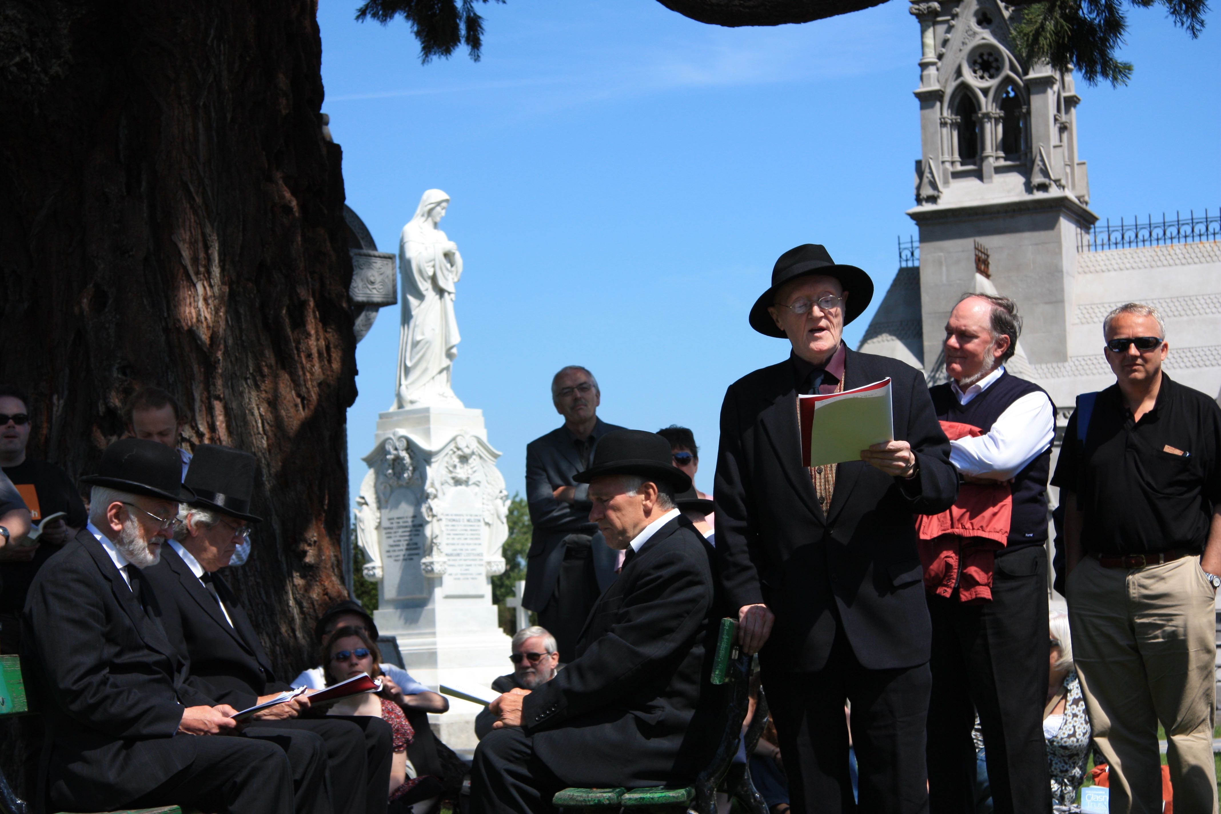 Reading Ulysses at  Glasnevin on the James Joyce Bloomsday tour.