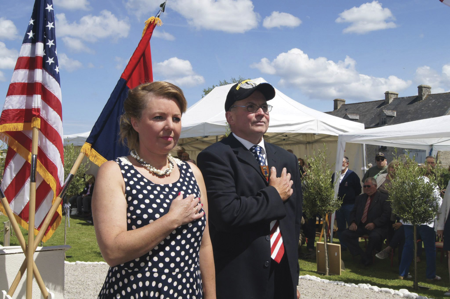 David Ashe and his partner, Céline Schwab Lautour, organize the annual ceremony at the Ravenoville Eternal Heroes Memorial. Ashe, the founder of the monument, believes in peace and reconciliation and flies both the U.S. and German flags.