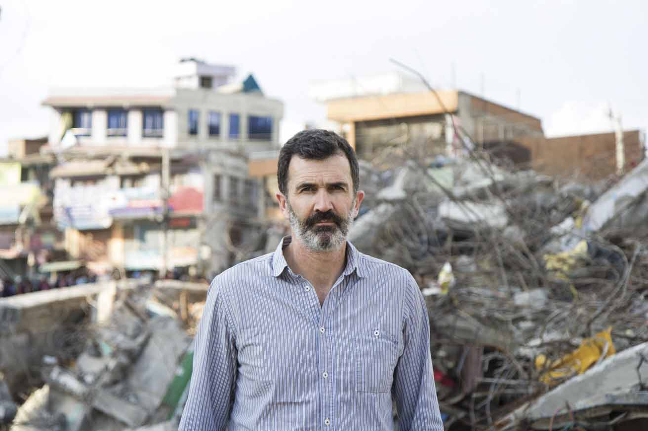 Kieran McConville standing in front of a collapsed building in Kathmandu. Kieran works in the Communications Unit of Concern Worldwide and travels extensively to document the organization’s emergency  response and development work around the world. He is originally from Limerick, Ireland and lives in New York City.