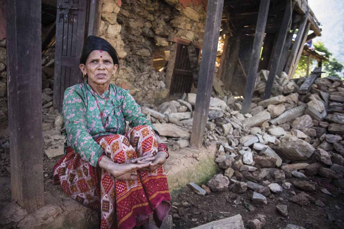 Tulasa Aryal, 58, sits on the porch of her earthquake-ravaged home in Bakrang, a village near the epicenter of the earthquake. A roughly hour drive from Gorkha, Bakrang is among the hardest hit villages in the 7.8-magnitude earthquake that hit Nepal on April 25. Out of 793 houses homes in Bakrang, 515 were completely destroyed.