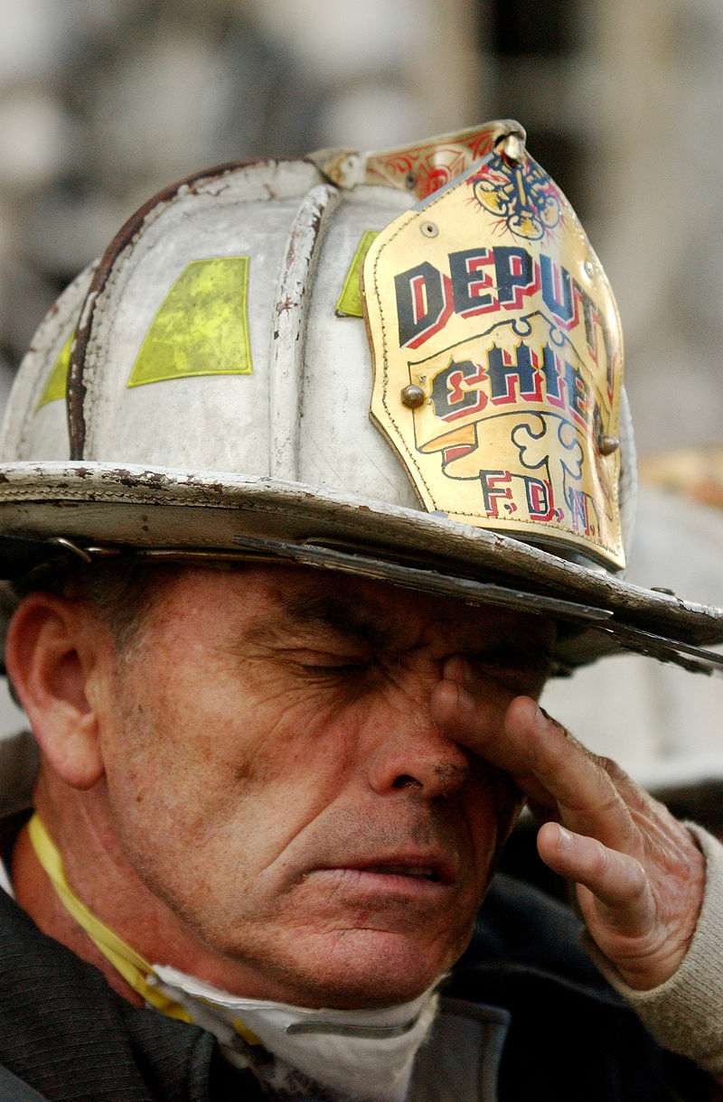 9/14/2001 – A New York City firefighter attempts to clear his eyes of soot during rescue efforts at the World Trade Center following the September 11, 2001, terrorist attack.