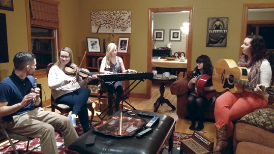 Rehearsal at the home of Rose  Flanagan, herself a former Cherish The Ladies fiddler, are flute player Sean Tierney, a regular guest performer with Girsa, Maeve Flanagan, Emily McShane, Bernadette Flanagan, and Pamela Geraghty.