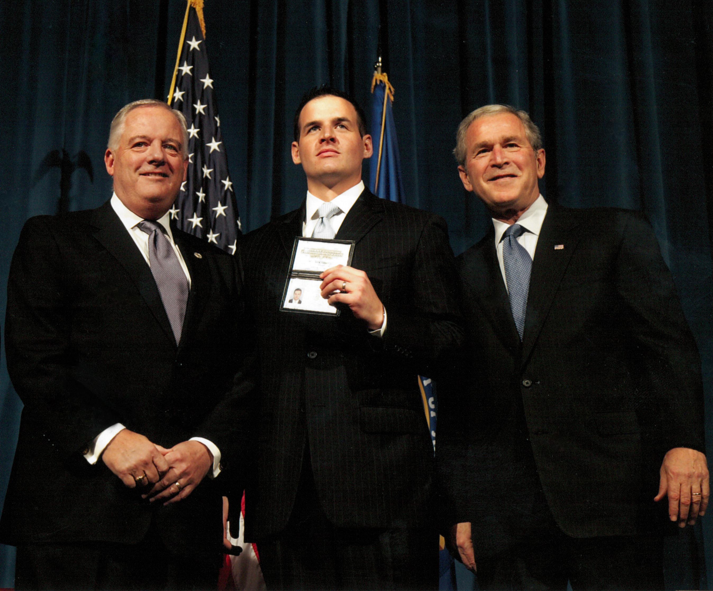 Kenney and son Brendan with President George W. Bush on the occasion of Brendan’s induction into the FBI. 