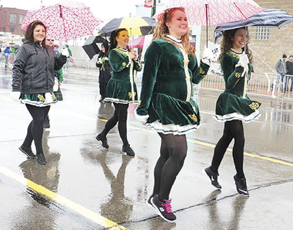 Irish step dancers march on a rainy St. Patrick's Day Parade in Detroit.