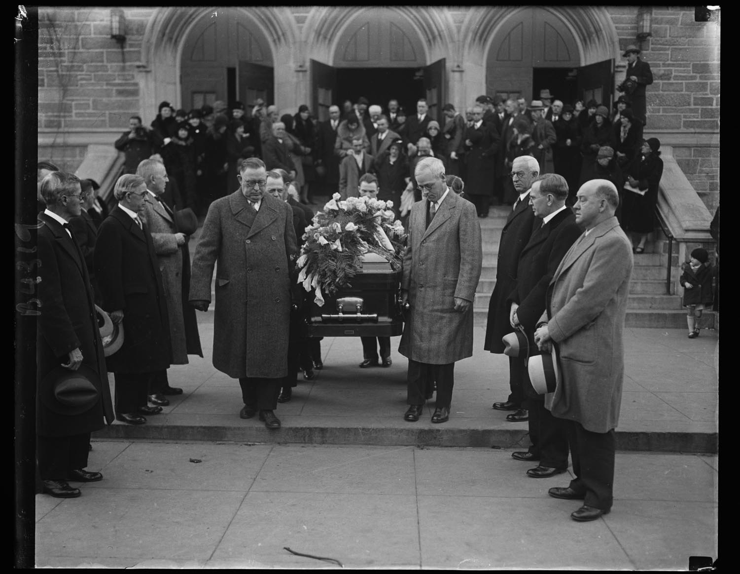 Men, high in the ranks of labor  circles, take part in the last rites for Mother Jones. At right, William N. Doak, newly  appointed Secretary of Labor. The casket is being borne from St. Gabriel's Catholic Church in Washington, D.C., where services were held, after which the body was sent to Mount Olivet, Illinois,  to be buried beside  five of her “boys" slain  in one of the many  labor wars in which  she participated,  December 3, 1930.