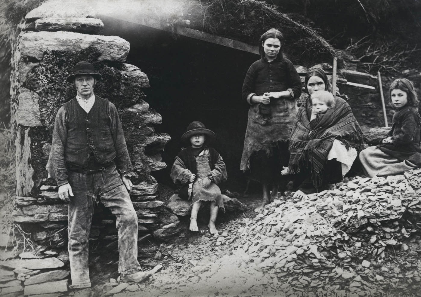 A family at the ruins of their house in Killarney, Co. Kerry, June 1897.