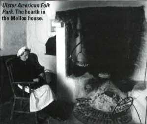 A woman doing an unknown task in front of the Hearth in the Mellon house at the Ulster American Folk Park. 