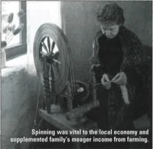 A woman using a spinner to create threads at the Ulster American Folk Park. 