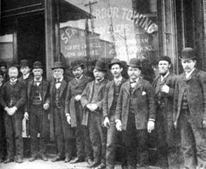 Michael Moran (holding cigar, fourth from the left), with his associates on South Street, then known as the Street of Ships.