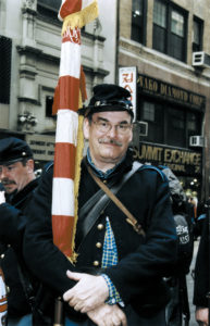 During the Parade, Stephan O'Neill removes his eyeglasses, which are not authentic Civil War era. Carrying the American flag, he marches blind, he says.