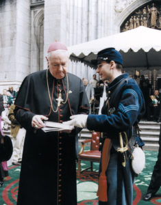 During the St. Patrick's Day Parade, Robert Carter presents Cardinal Egan with Memoirs of Chaplain Life by Father William Corby, a chaplain of the original Irish Brigade.