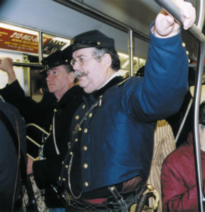 Irish Brigade reenactors take the Lexington Avenue subway from the 69th Regiment Armory on 26th Street to the midtown area where the St. Patrick's Day Parade begins. Rush-hour straphangers seem unfazed by their presence.