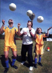 Special Olympic athletes from Cyprus, Emilios Loannou (left) and Petrov Kleovoulos (right), receive soccer tips from coach Roman Koseckiv.