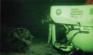 Pisces IV by the stern of the midget submarine.