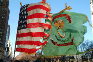 The U.S. flag and the flag of the Irish brigade fly together. Photo courtesy of the 69th NYSV Historical Association