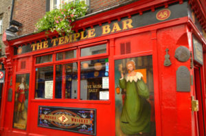 The Temple Bar Pubfront in close up with artwork of medieval characters.