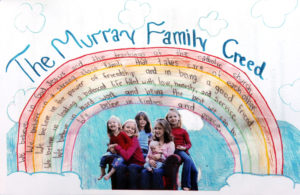 A photo of the six Murray girls with their family creed graced the back of the program for services for the girls' mother and sister who died when a tree fell on their van during a storm.  The girls are from left, Quinn, Jillian, Maeve, Meghan holding Kieran and Sloan, right, who was killed. Photo: Katherine Frey / The Washington Post