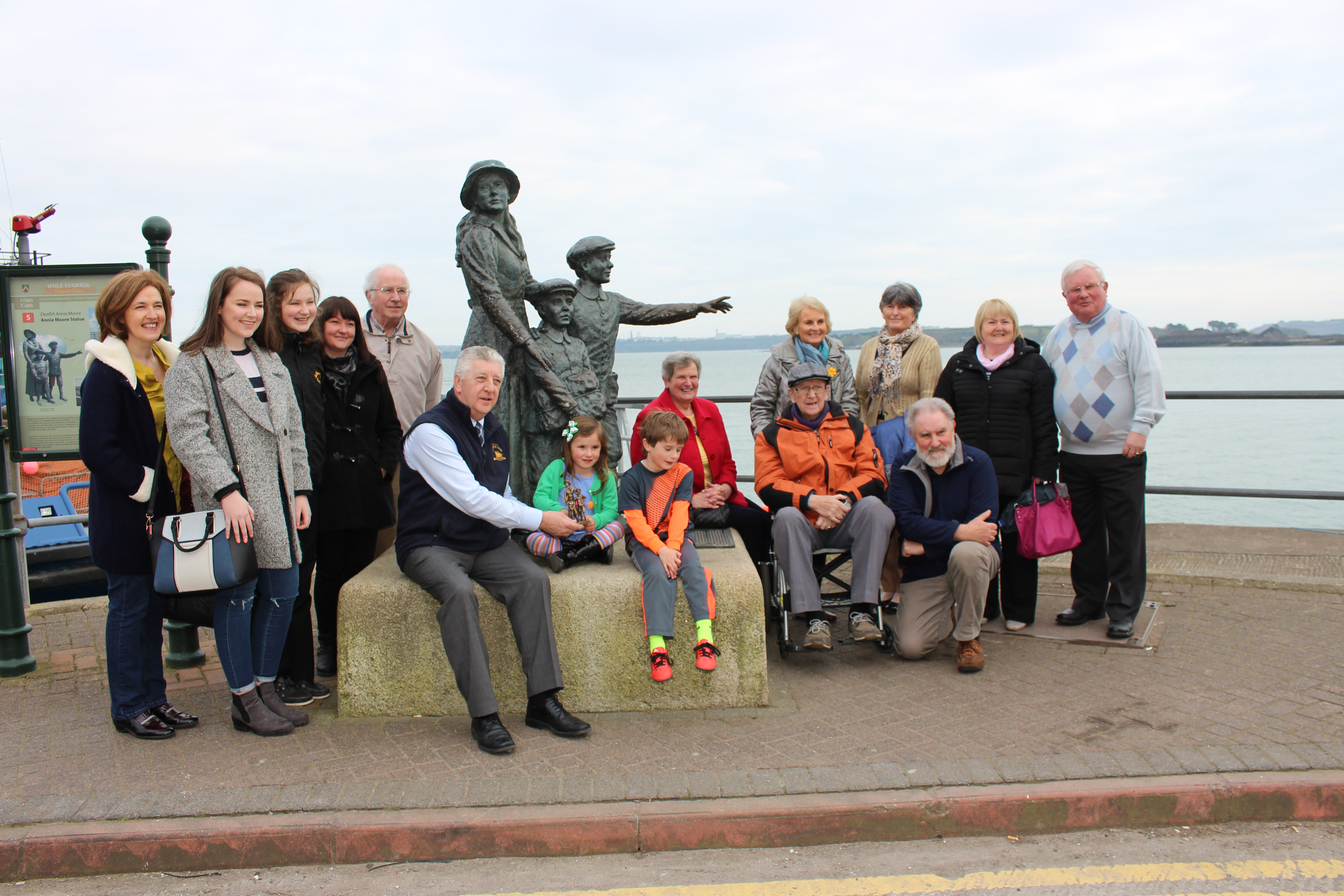 Several generations of Annie Moore’s Irish  relatives gather at her statue at the Cobh  Heritage Centre to  celebrate their famous cousin.