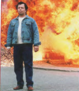 IRA bomber Broderick Dooley (Curtis Armstrong) walks away from handiwork.