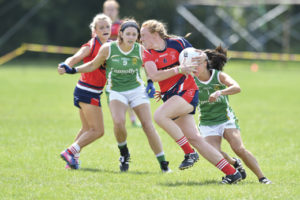 A Chicago St. Brigid's player flying by her Charlotte James Connolly's opponent.