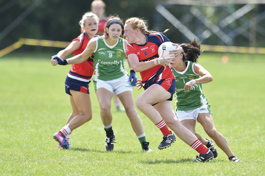 <em>A Chicago St. Brigid's player flying by her Charlotte James Connolly's opponent.</em>