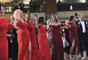 Ladies dance along as Chris de Burgh sings his famous hit song "The Lady in Red."