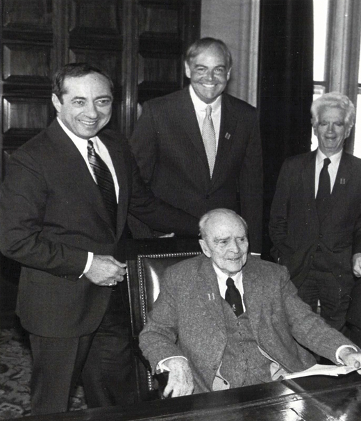 <em>Albany introduces Dearie’s bill, the MacBride Principles, signed into law later that year by Gov. Mario Cuomo (first in the nation). Clockwise from left: Gov. Cuomo, John Dearie, Paul O’Dwyer, and Sean MacBride. 1986.</em>