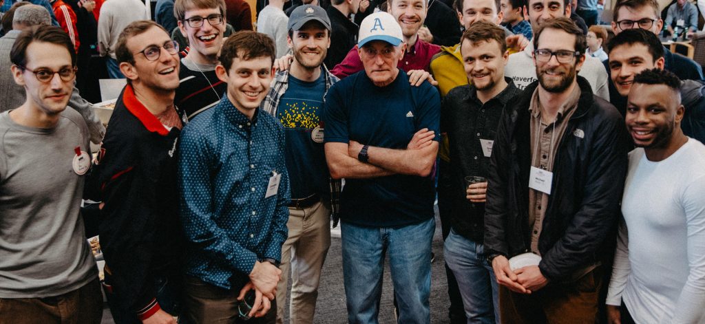 Coach Tom Donnelly is surrounded by Haverford alums and former team members at a 2020 event celebrating Donnelly's 45th season. Photo by Holden Blanco '17, Haverford College.