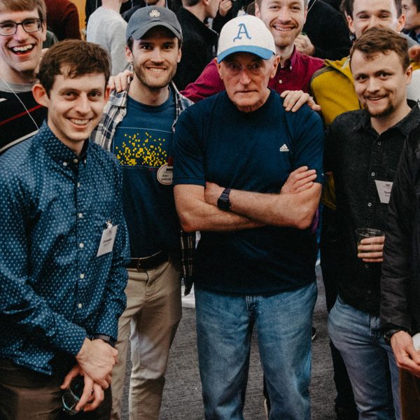 Coach Tom Donnelly is surrounded by Haverford alums and former team members at a 2020 event celebrating Donnelly's 45th season. Photo by Holden Blanco '17, Haverford College.