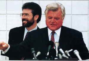 October, 1994 at Logan Airport, Boston. Gerry Adams stands behind Senator Ted Kennedy speaking at the podium, lending his support. 