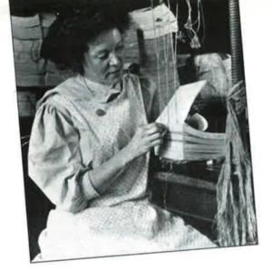 A black and white photo of an Irish woman working as a bookbinder in America, c. 1910.