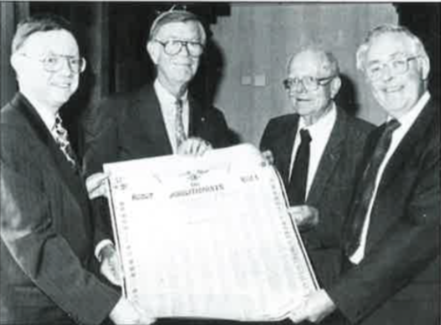 Professor Maurice O'Connell, the great-grandson of Daniel O'Connell stands with three other men holding the "Honor Roll of Abolitionists" poster, signed by over 60,000 Irish people and brought to America by Daniel O'Connell in 1842. 