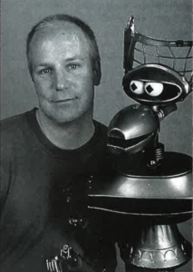 Bill Corbett, voice of "Crow T. Robot" on Mystery Science Theater 3000 poses with the TV robot. 