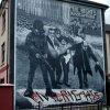 Bogside mural on Lecky Street, Londonderry. The mural depicts the famous photo of Father Edward Daly, waving a blood-stained white handkerchief as he escorts a mortally-wounded protester to safety during the events of Bloody Sunday (1972) in Derry, Northern Ireland.