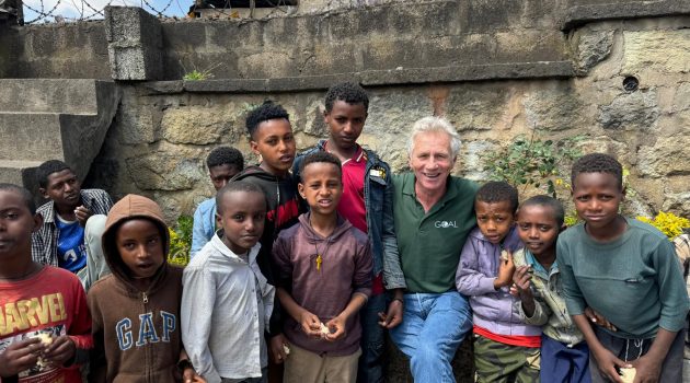 GOAL Ambassador and Irish running legend Eamonn Coghlan with boys participating in the organization's ChildSPACE project.